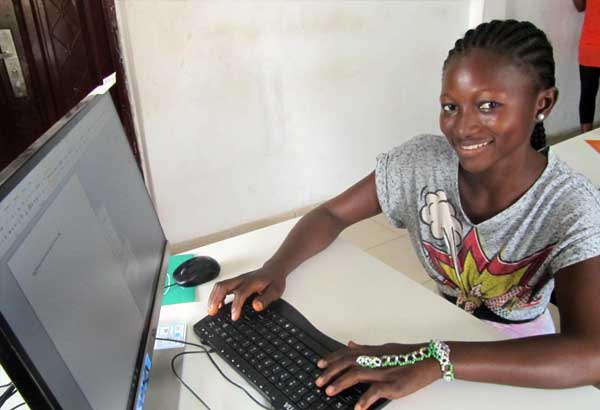 一名年轻女子在使用电脑时微笑
